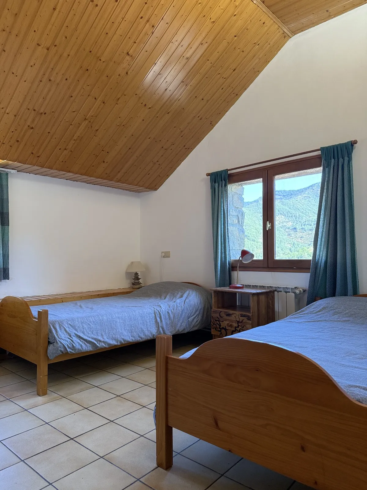 Dormitorio en madera con camas individuales, ideal para retiros y convivencias.